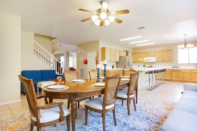 Open dining area with wooden table and modern lighting