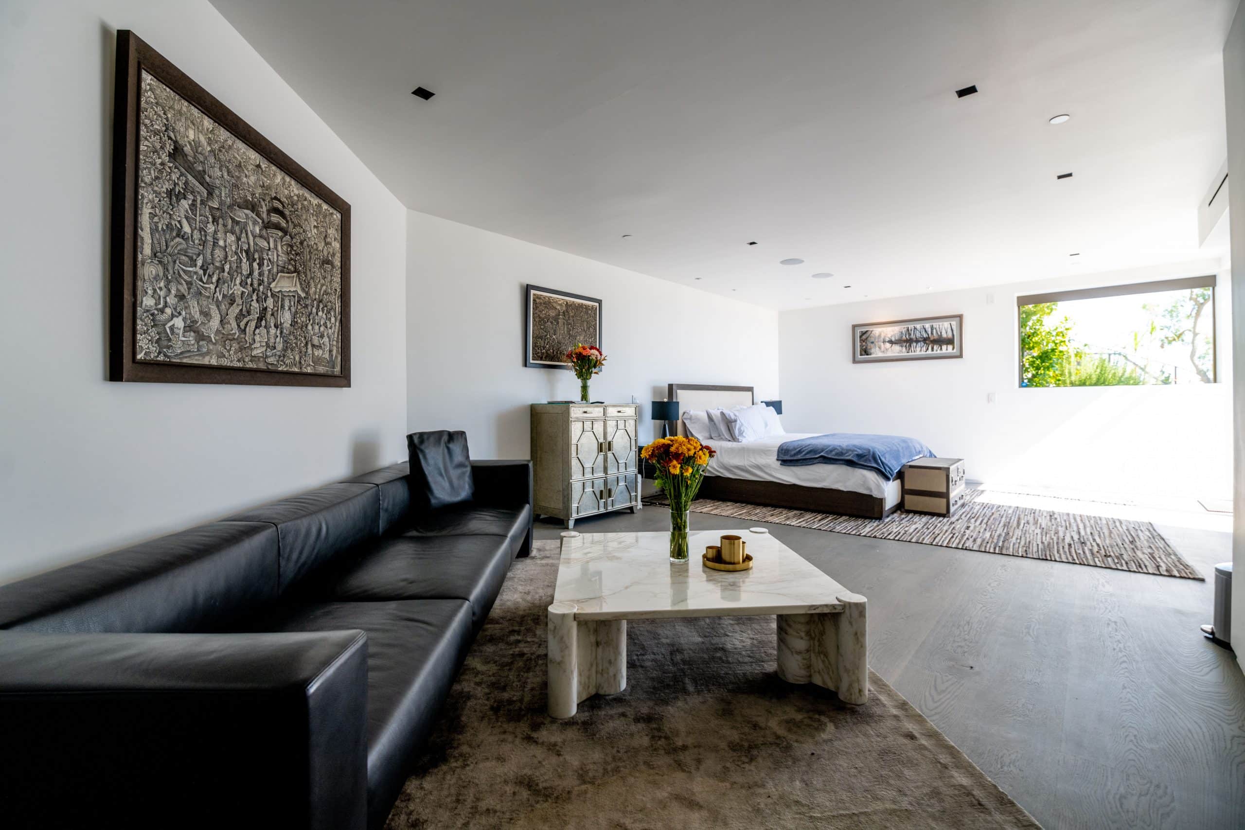 Private bedroom with sitting area and natural light