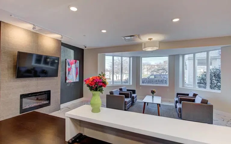 Common area with fireplace, television, tables, and chairs