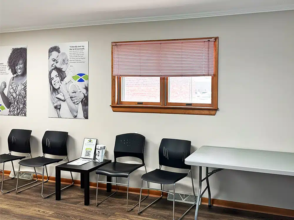 Waiting room chairs with small table and wall posters