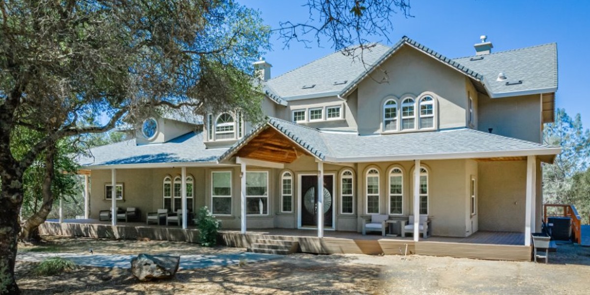 Large residential-style treatment facility surrounded by trees.