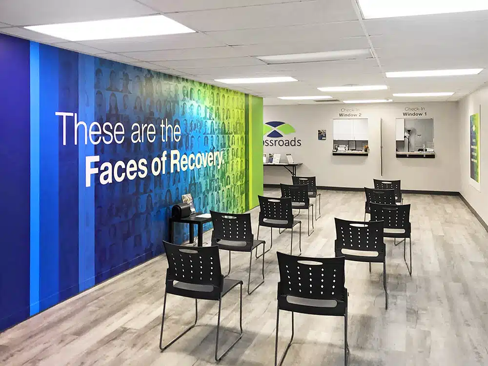Waiting room with chairs and check-in windows at facility