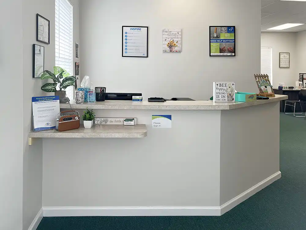 Front desk with sign-in area and informational materials