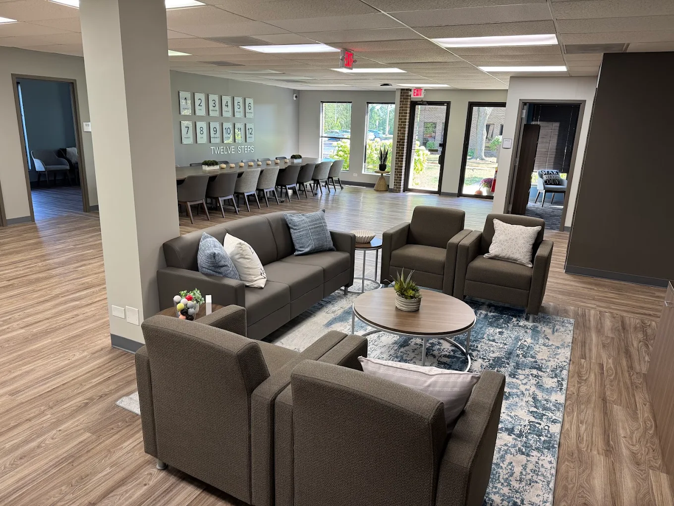 Spacious lounge with sofas, armchairs, and coffee tables
