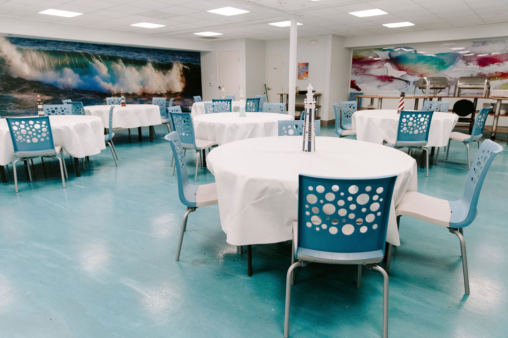 Dining area with round tables and blue chairs