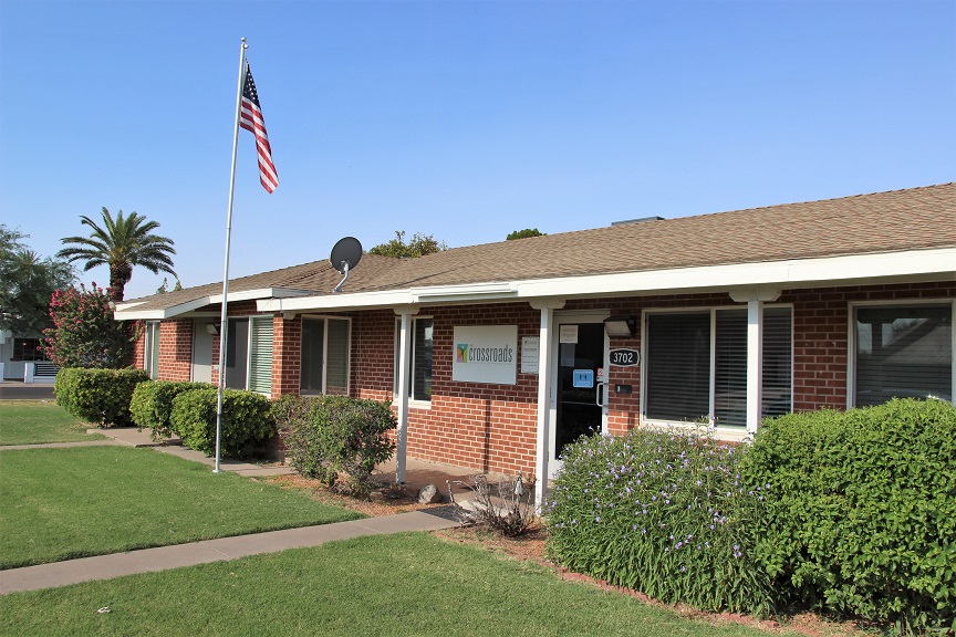 Facility entrance with brick exterior and American flag