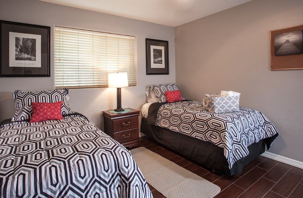 Shared bedroom with two beds, and a dresser.