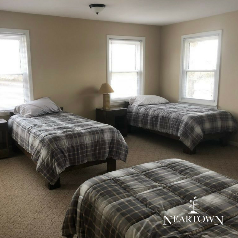 Room with three beds and checkered bedding