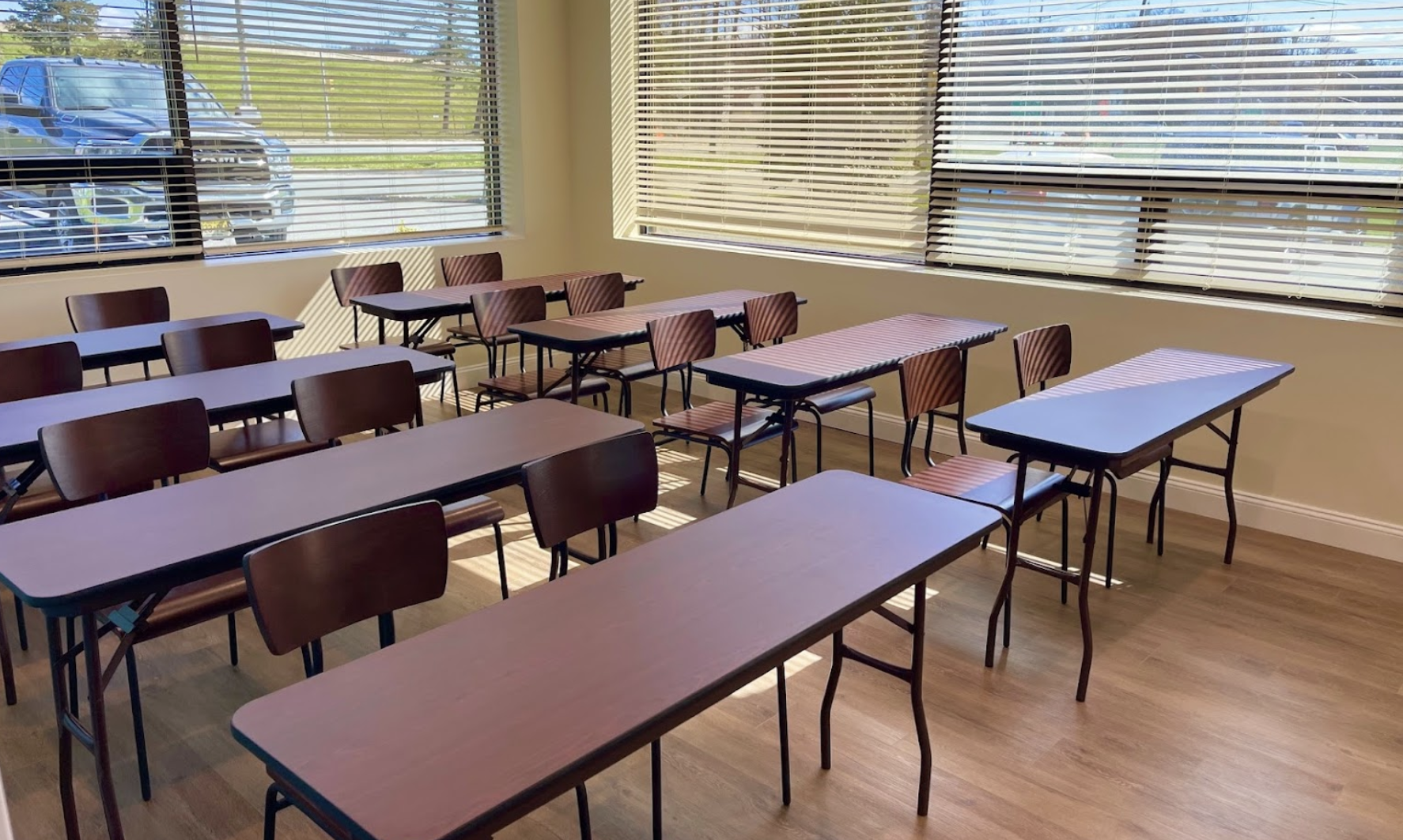 Classroom with desks and chairs by windows