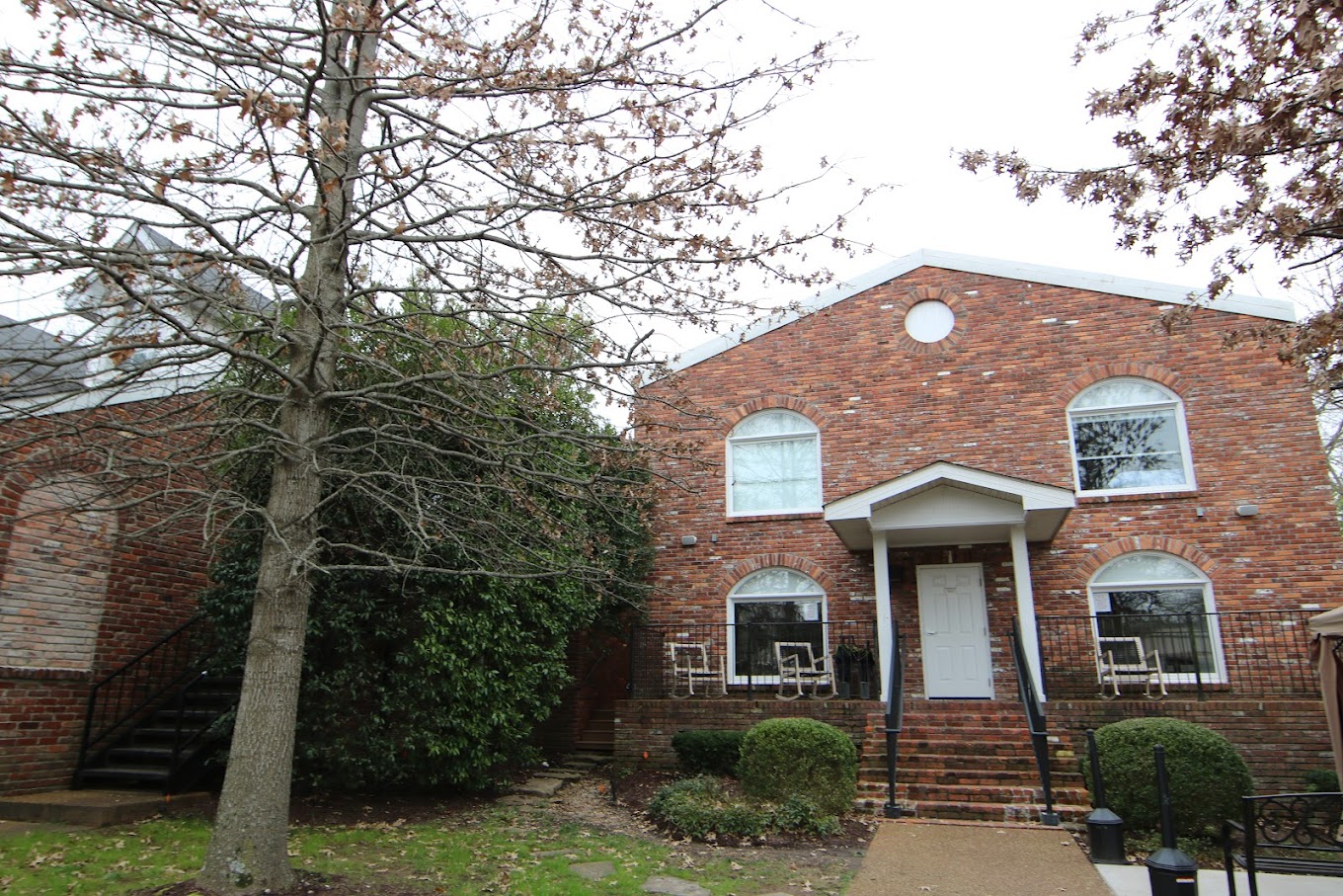 Brick facility entrance with white door and porch steps