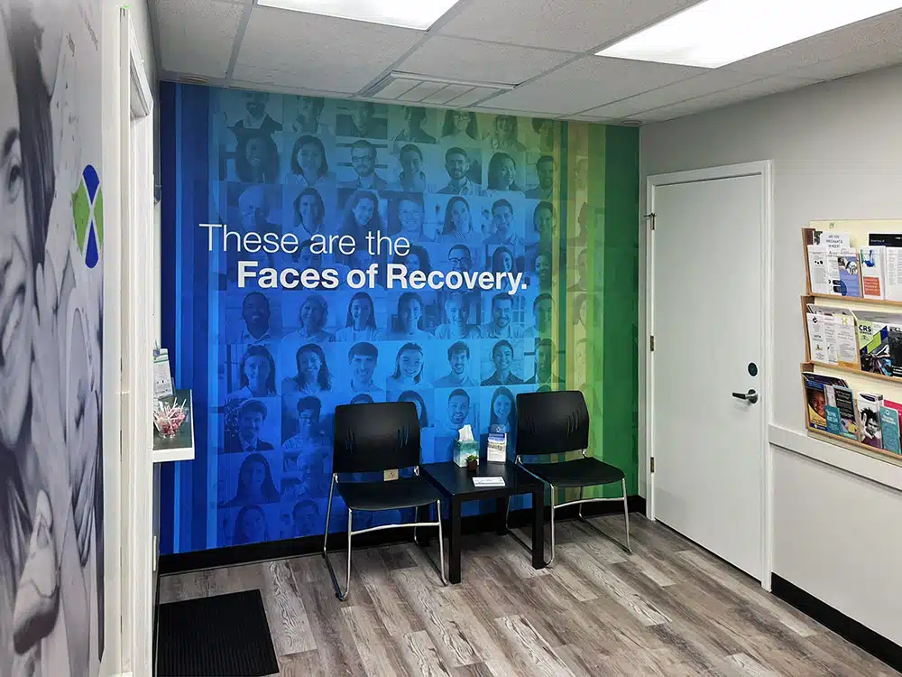 Waiting area with chairs and recovery wall mural