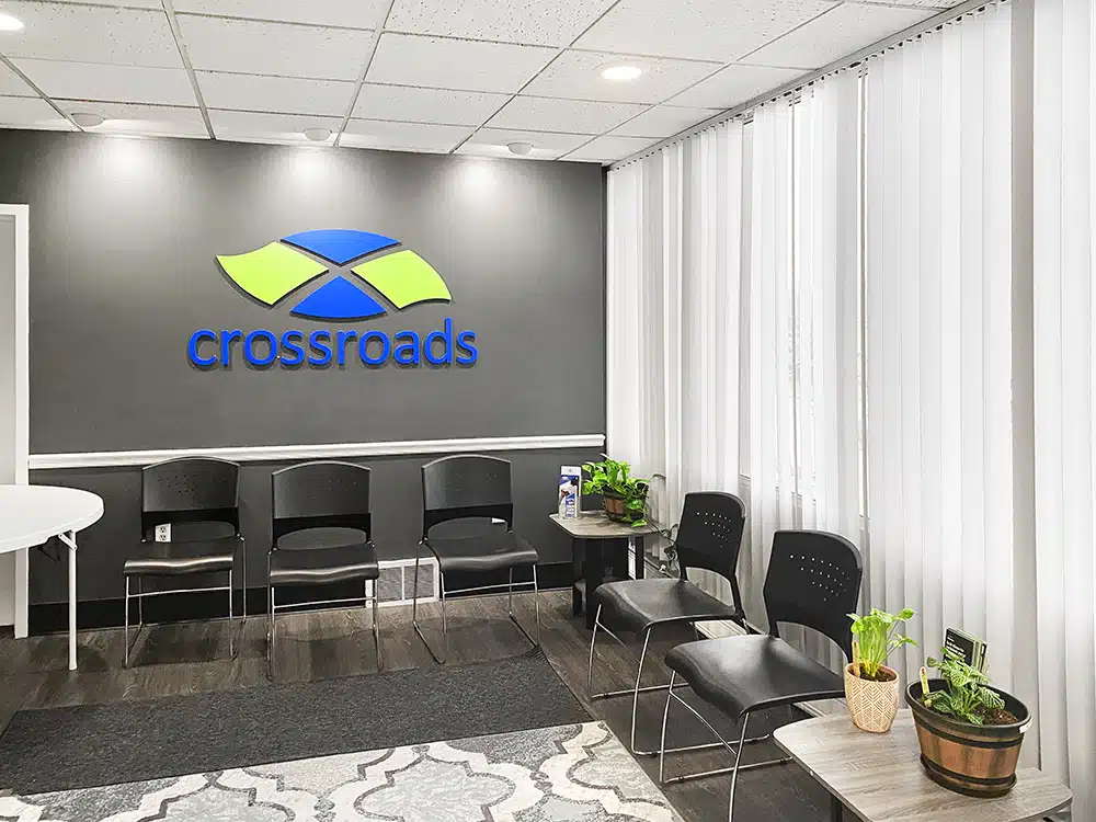 Waiting area with chairs, plants, and Crossroads logo