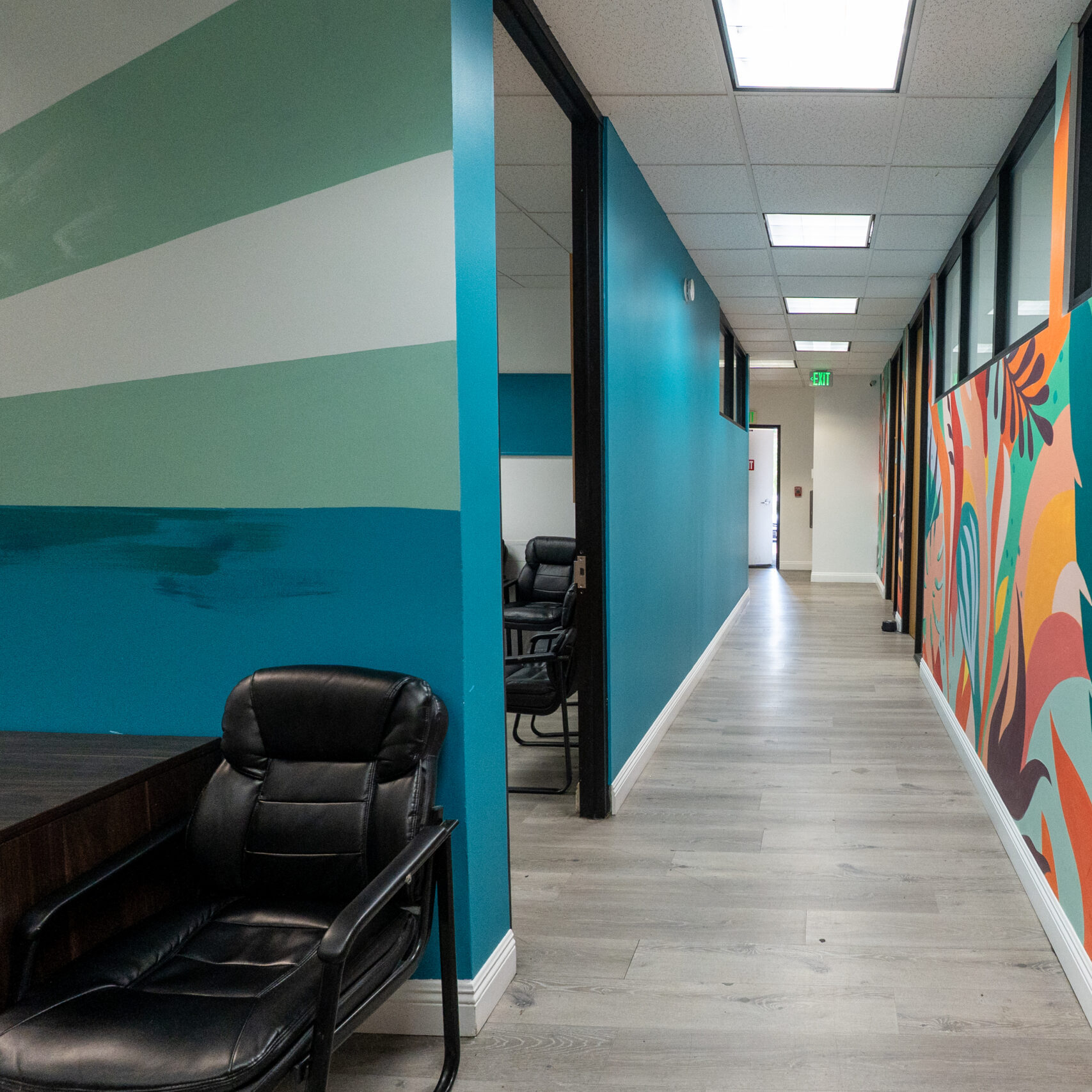 Colorful hallway with office chairs and bright wall murals