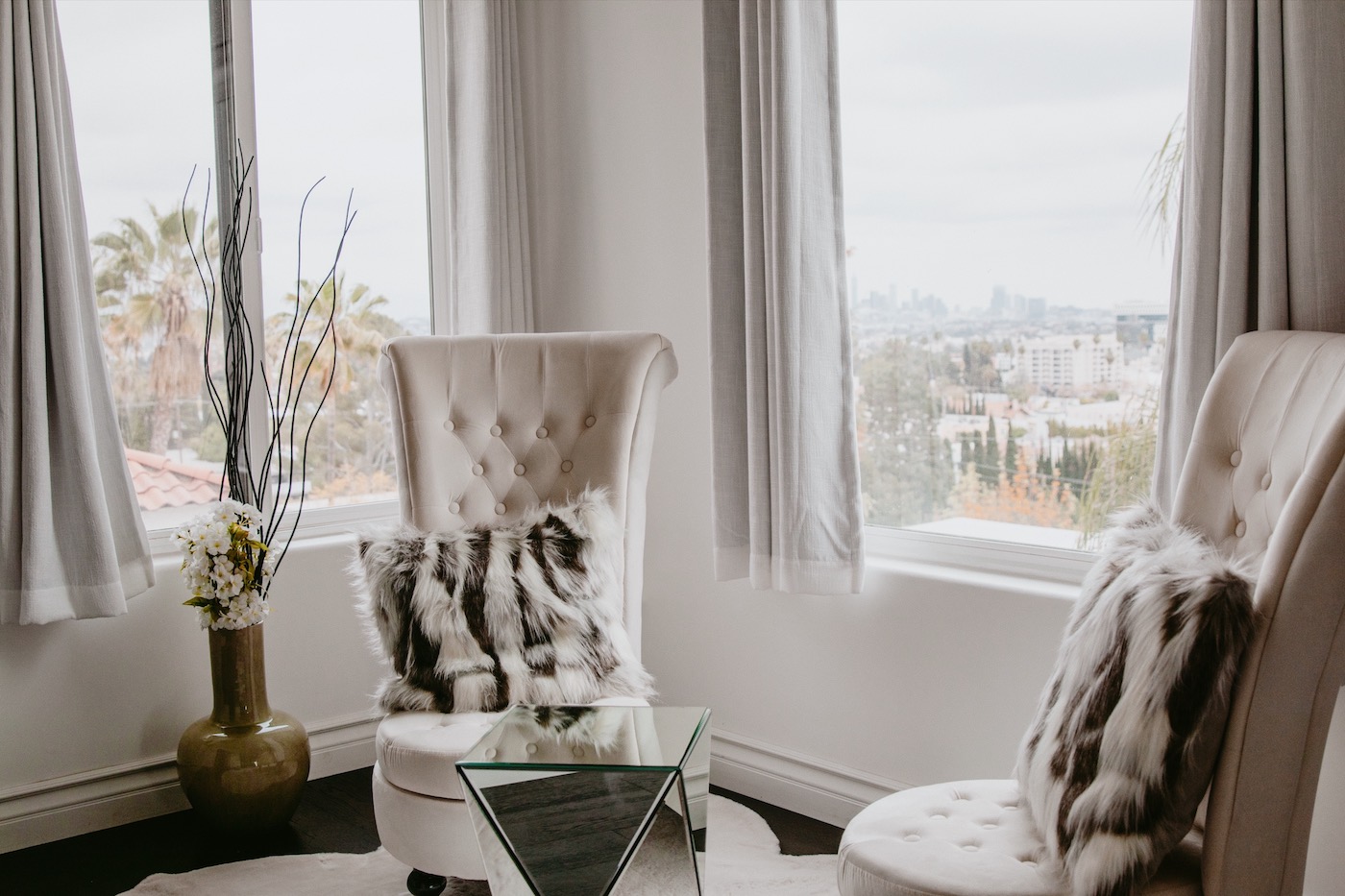 Sitting area with city views and high-back chairs