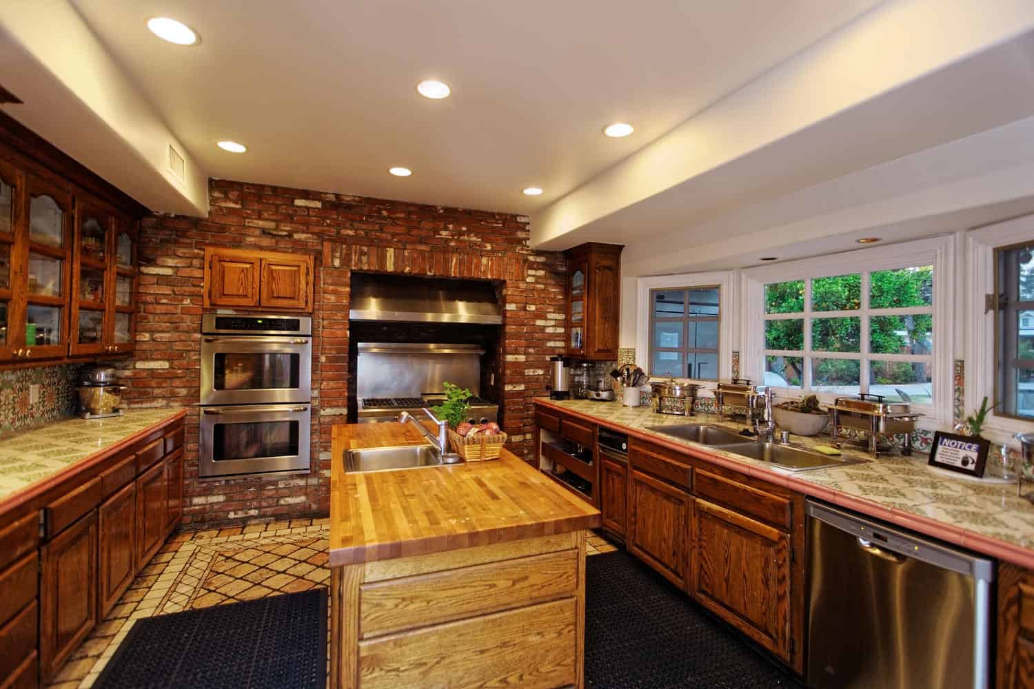 Large kitchen with wood cabinets and double ovens