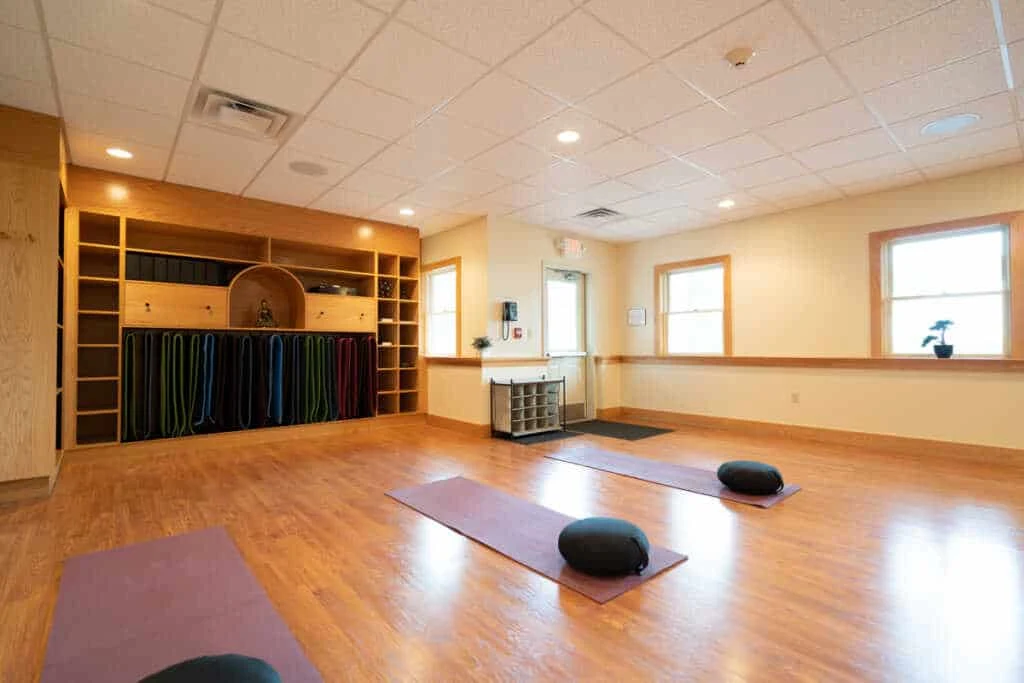 Yoga mats and cushions set up in peaceful room