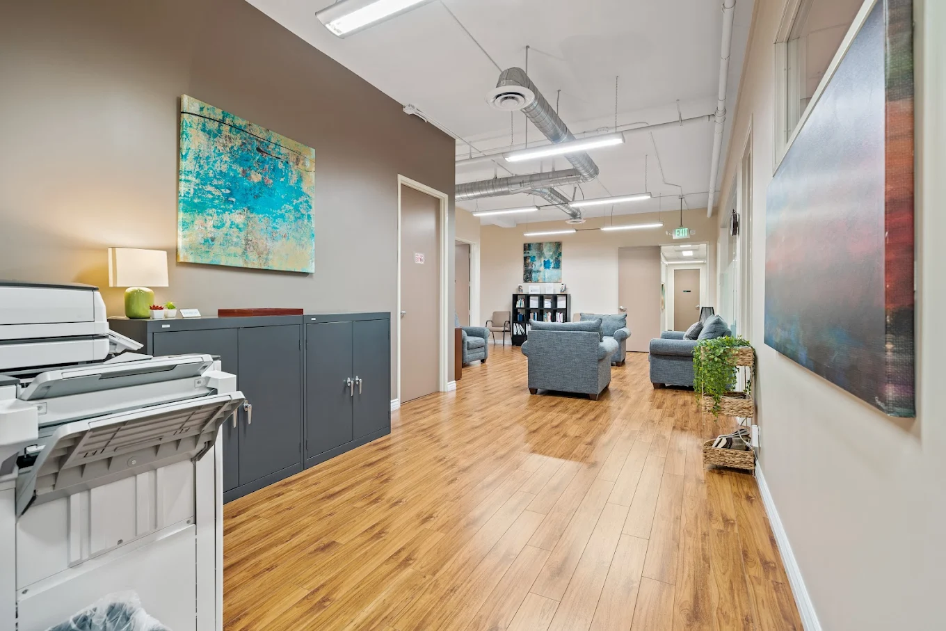 Hallway with lounge seating and office access