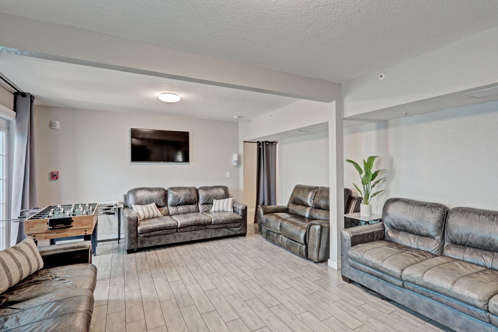Lounge with leather couches, foosball, and TV