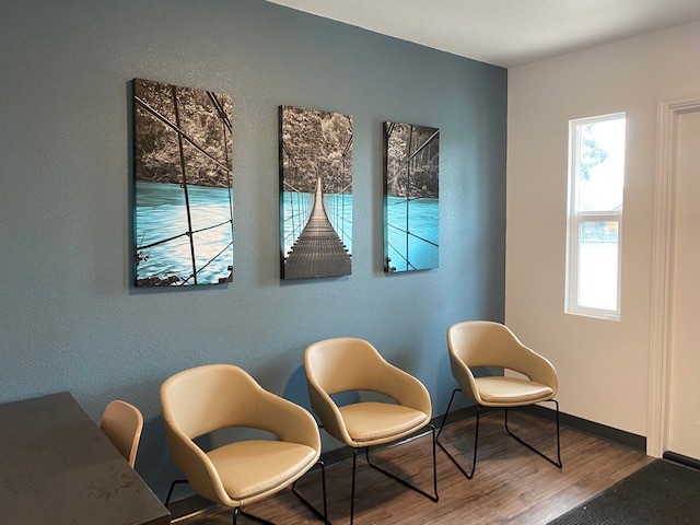 Waiting area with chairs and calming wall artwork