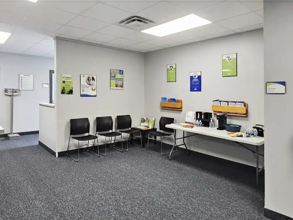 Waiting room with chairs, brochures, and refreshment table