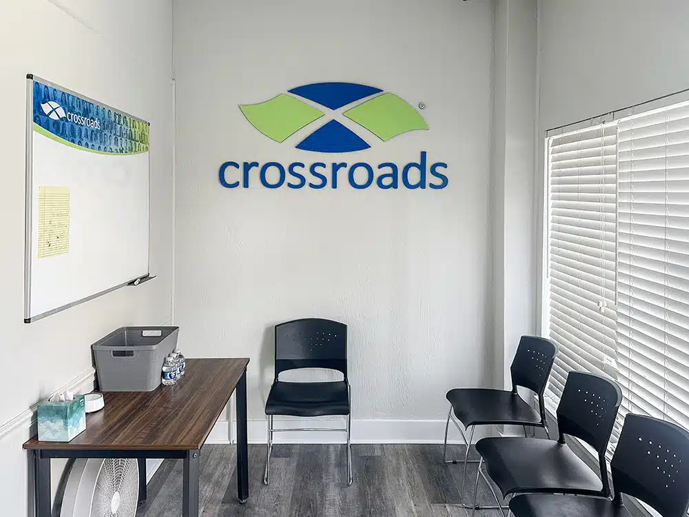 Group room with chairs, whiteboard, and Crossroads logo