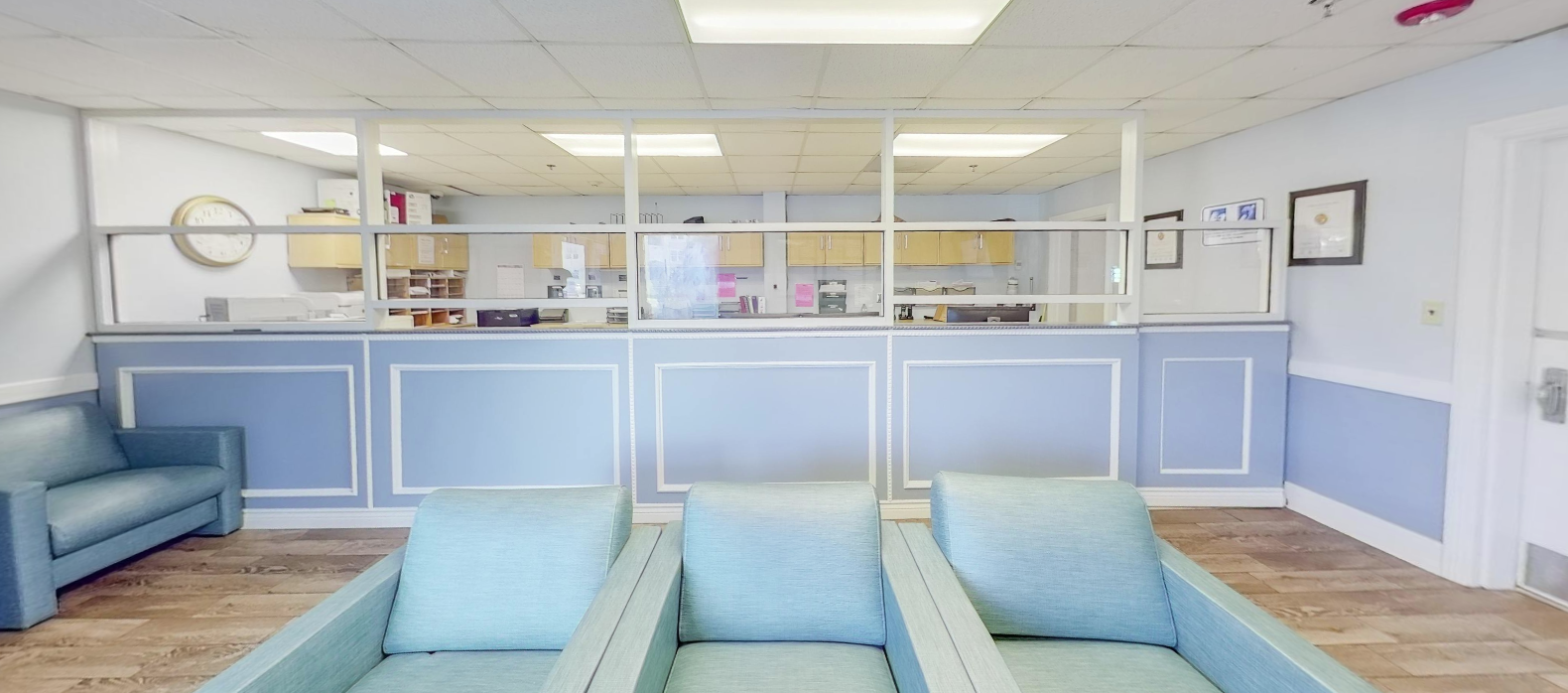 Reception desk with waiting area and blue seating