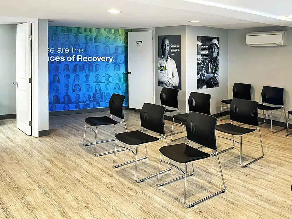 Group therapy room with chairs and recovery wall mural