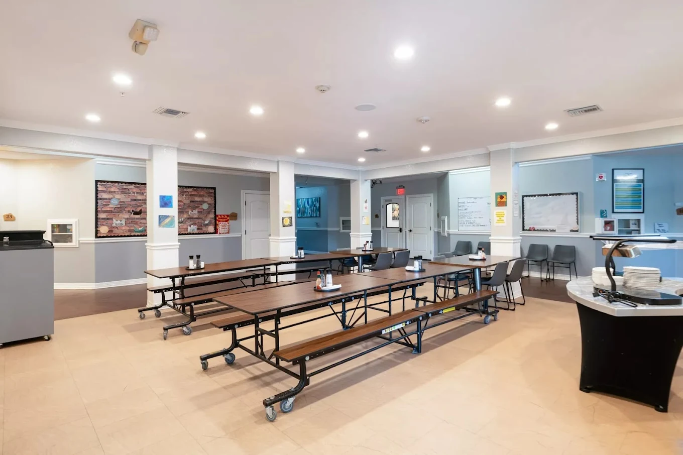 Dining area with cafeteria-style seating and serving station
