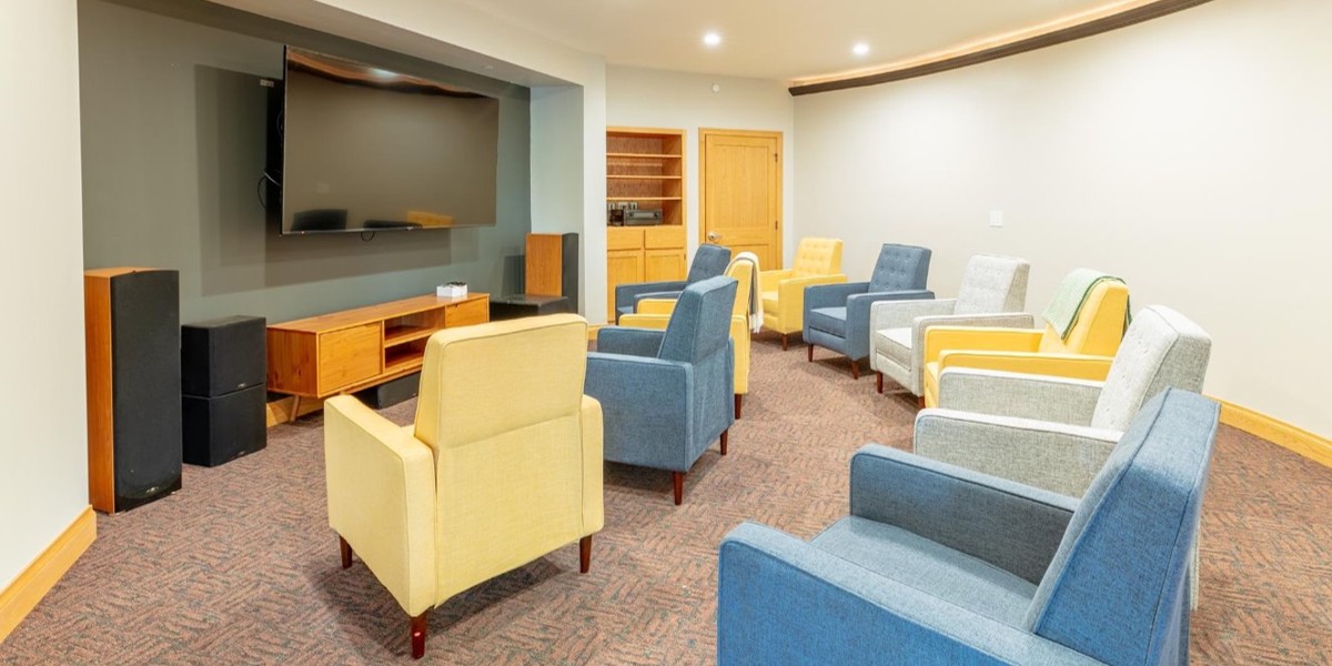 Theatre room with armchairs facing large TV screen