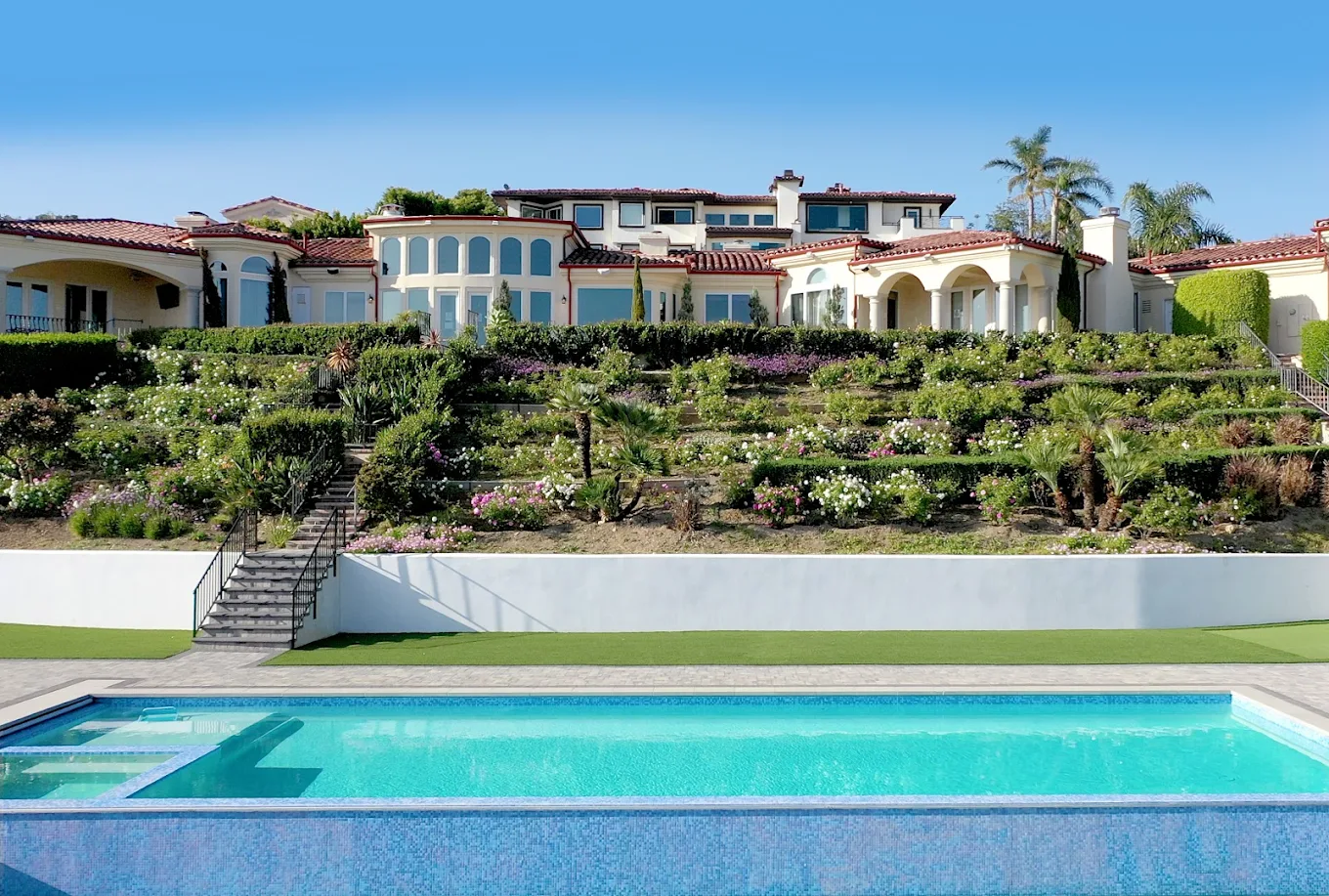 Large outdoor pool facing the hillside and residence
