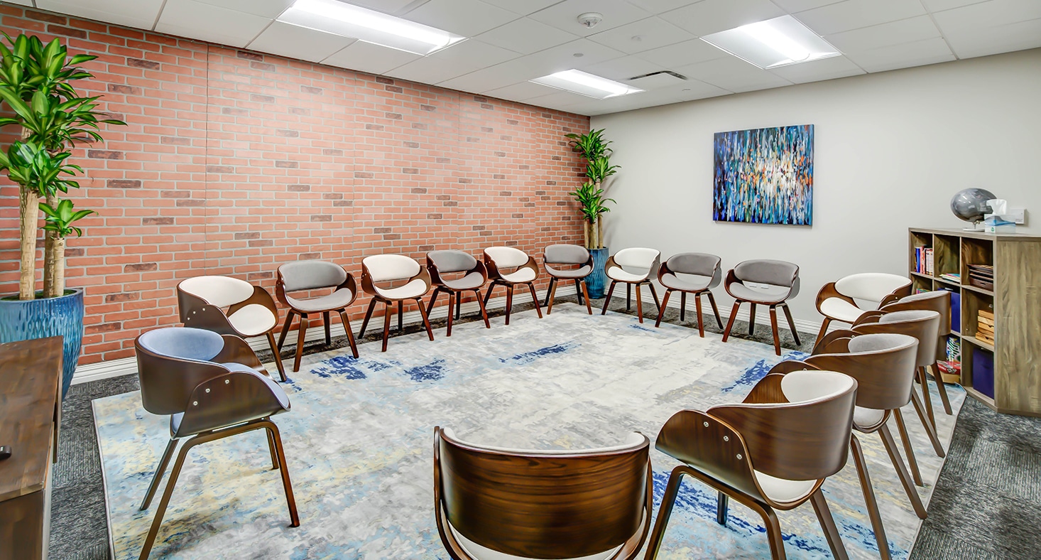 Modern group therapy room with circle of chairs