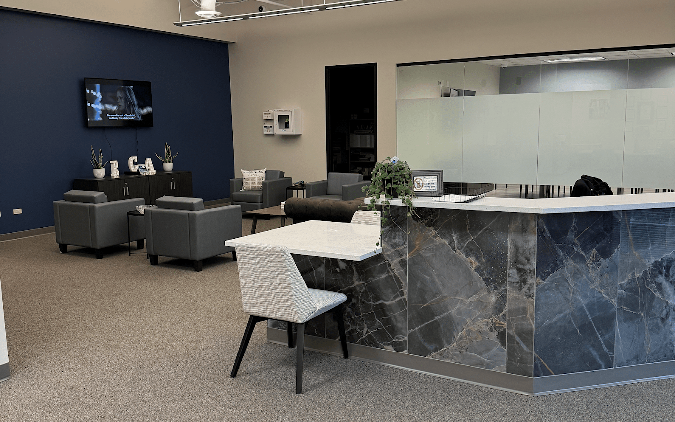 Reception desk beside lounge seating at the treatment center