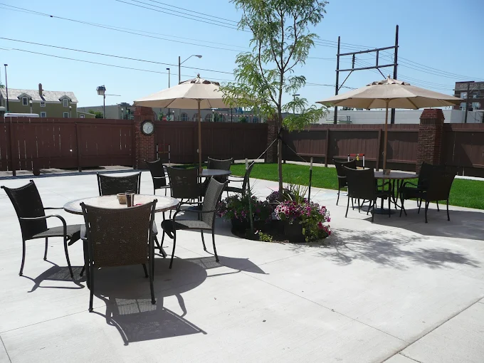 Patio seating area with umbrellas and flowers