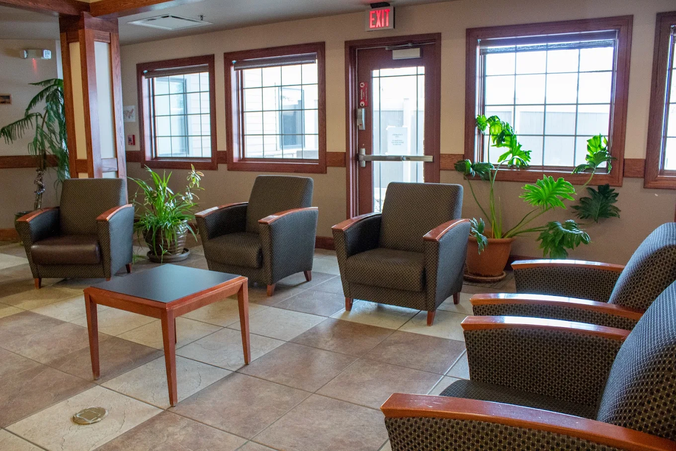Bright lobby seating area with chairs and indoor plants