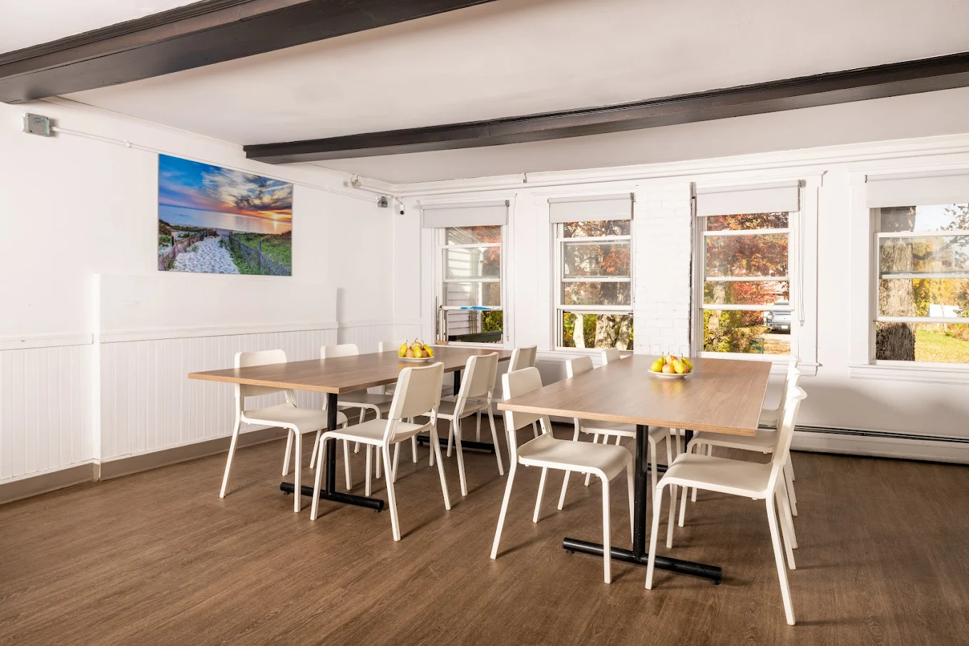 Modern dining room with two tables and white chairs