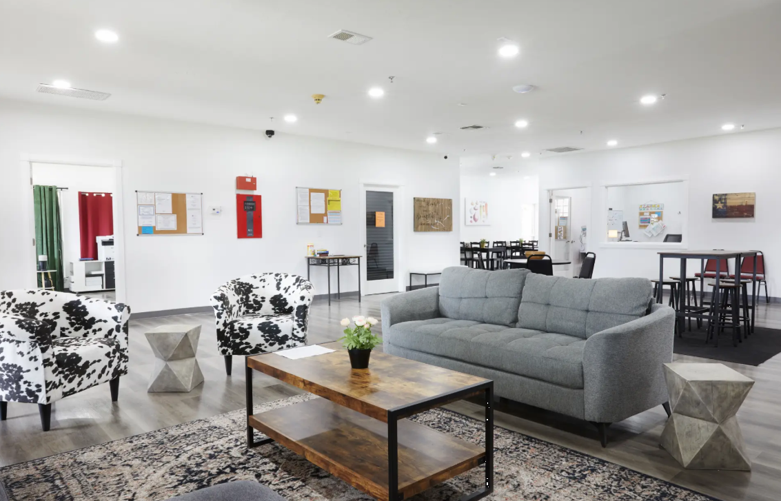 Bright lounge with sofa, chairs, and tables