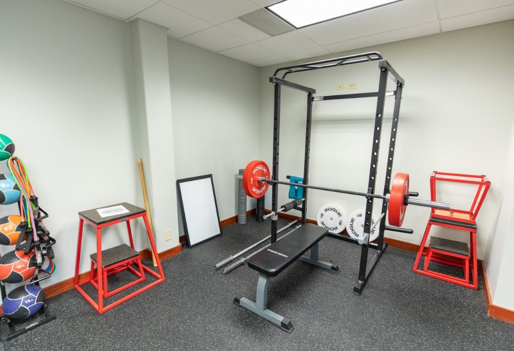 Fitness room with weights, bench, and exercise equipment