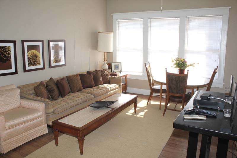 Living area with sofa, coffee table, and large window light