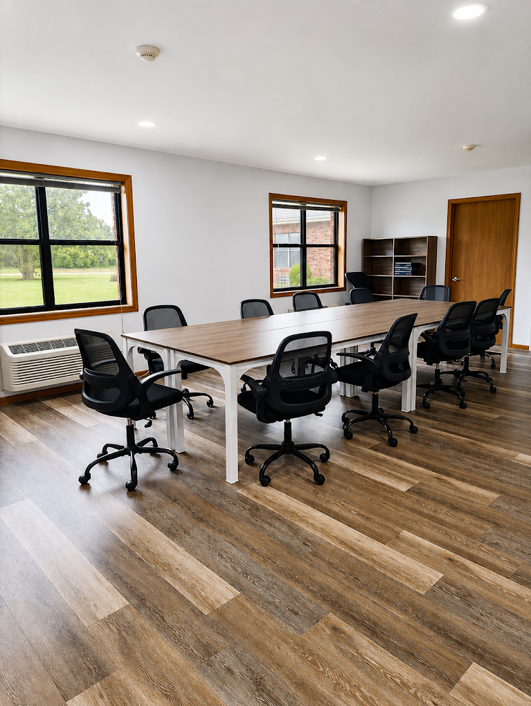 Meeting room with conference table, chairs, and large windows