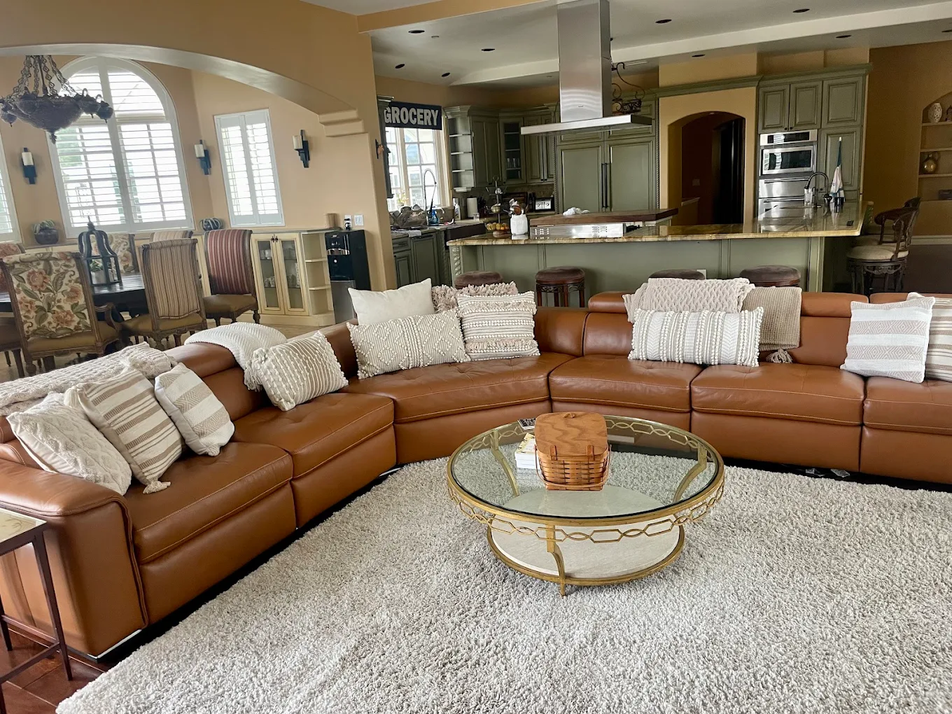 Large leather sectional facing a round glass table