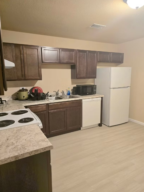 Modern kitchen with dark cabinets and white appliances