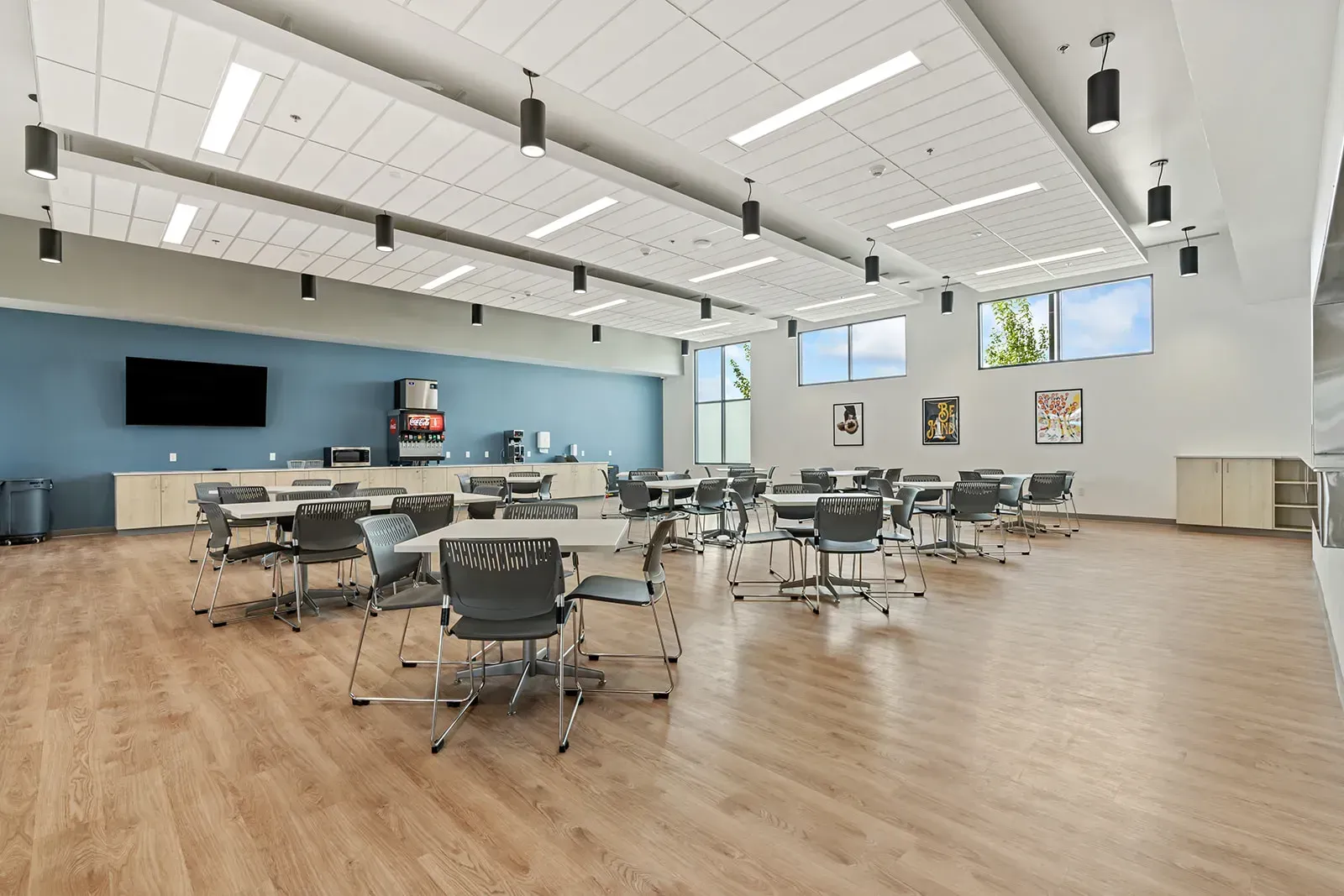 Large dining area with tables, chairs, and beverage station