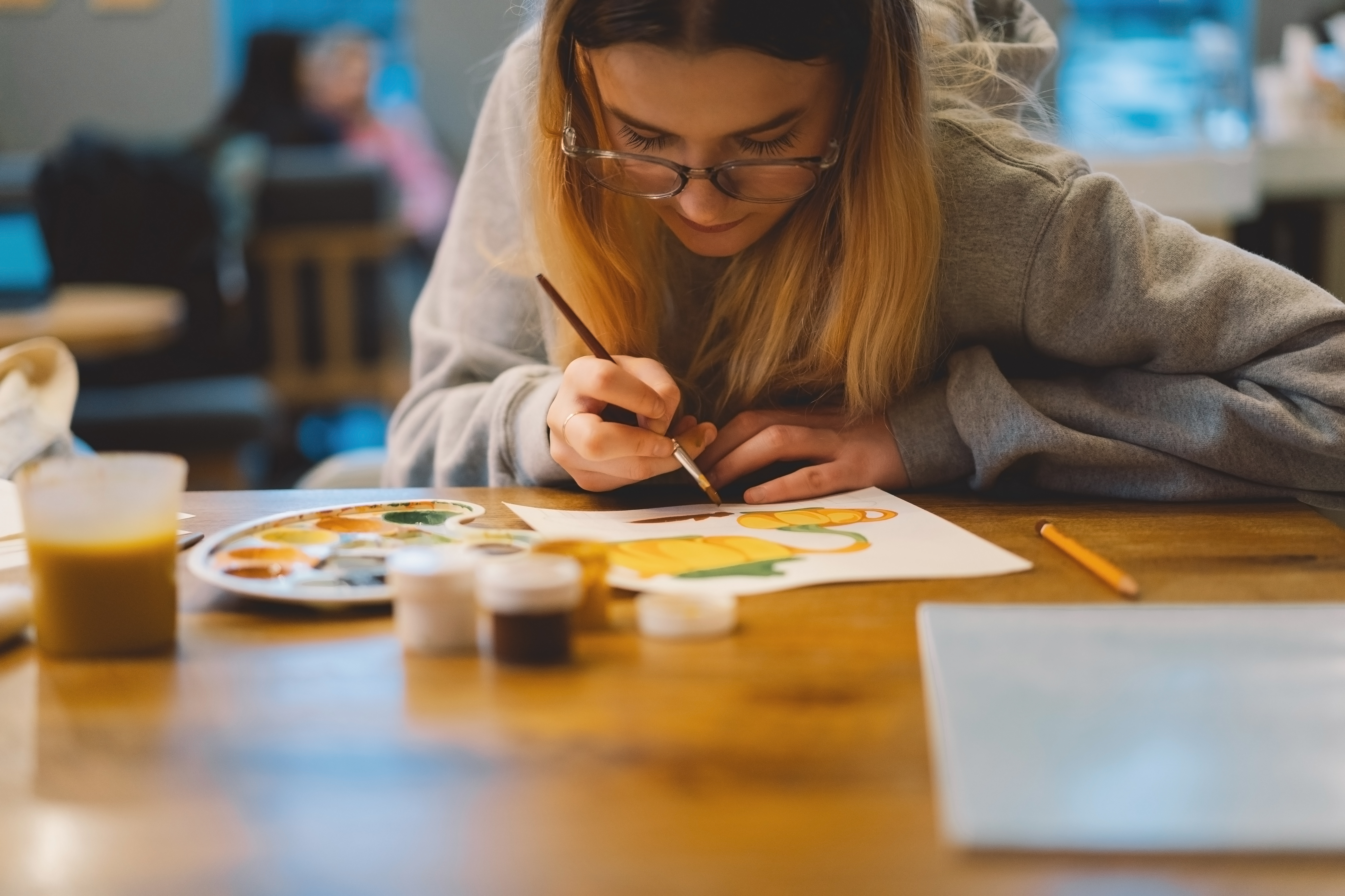 Teen girl painting during an art therapy session.