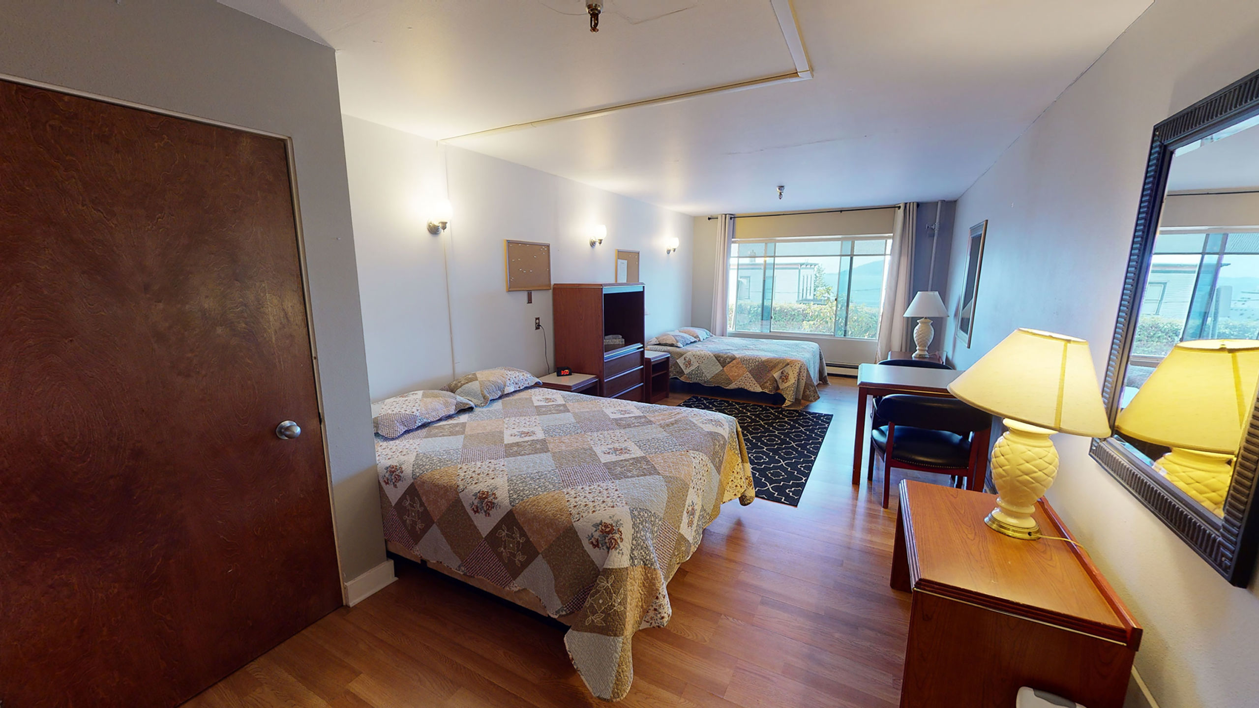 Room with two beds and a window facing ocean view