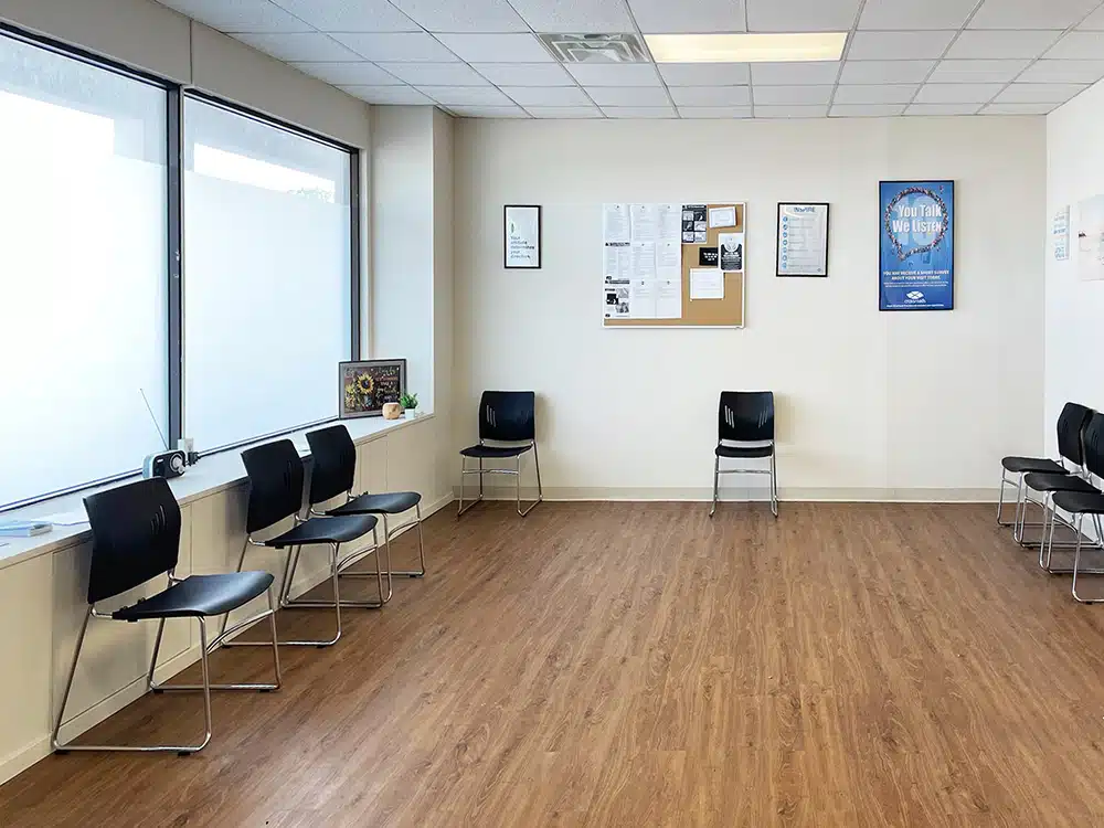 Waiting room with chairs and bulletin board on wall