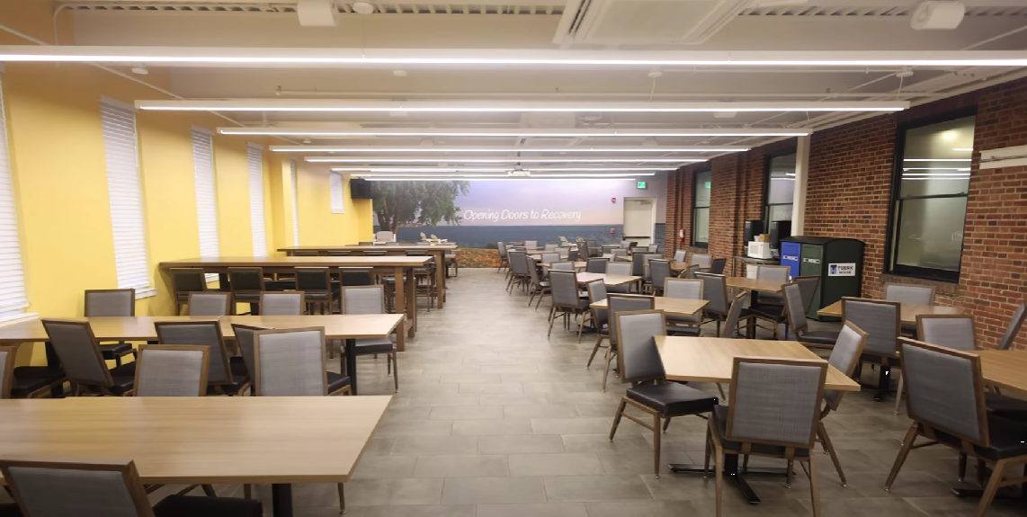 Bright dining hall with multiple tables and chairs