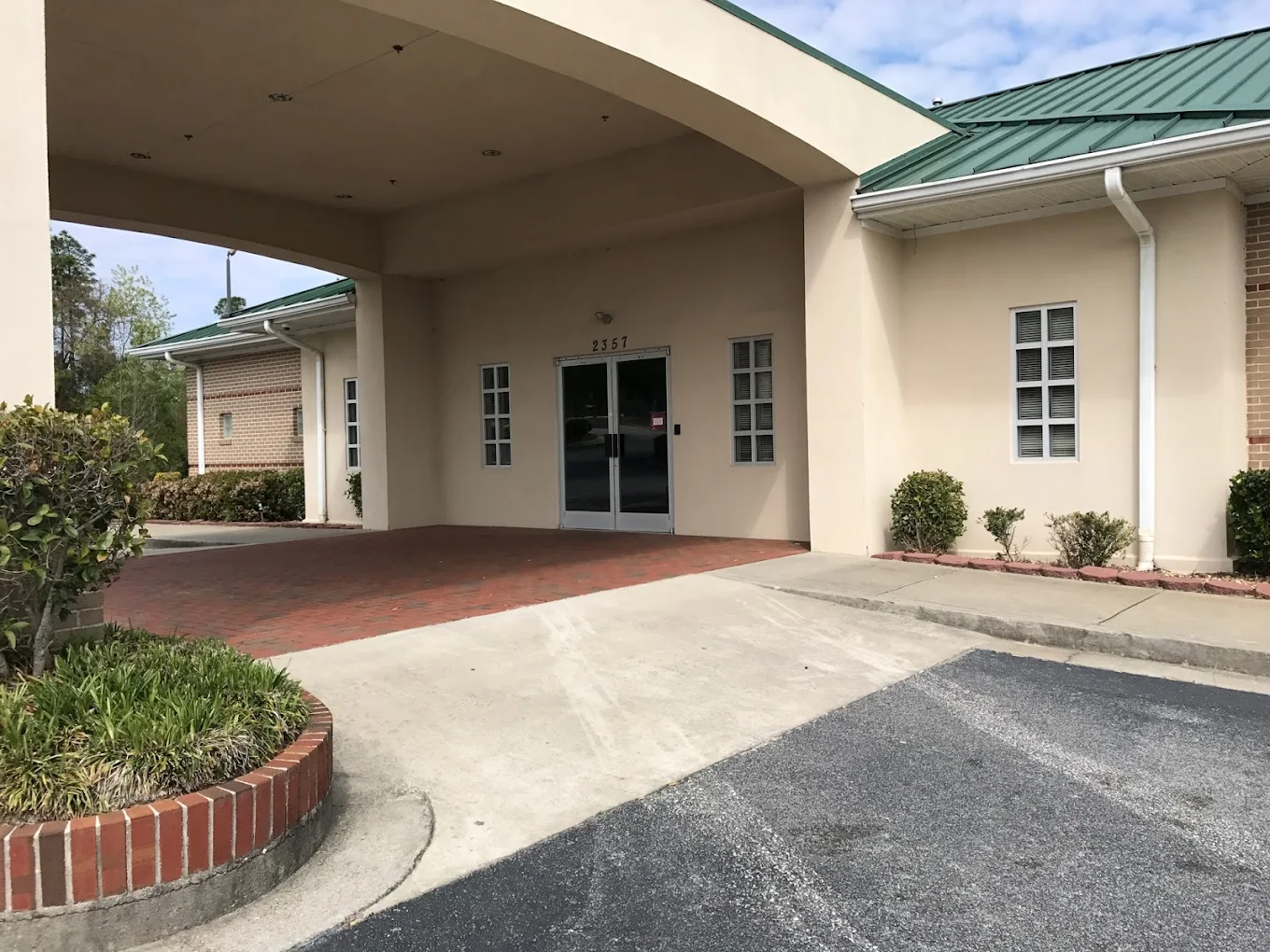 Covered entrance with driveway at rehab facility entrance