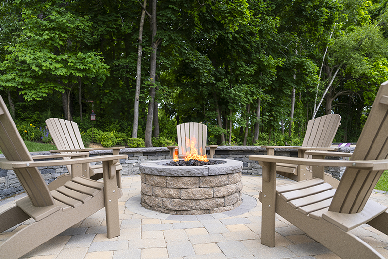 Adirondack chairs surrounding outdoor fire pit