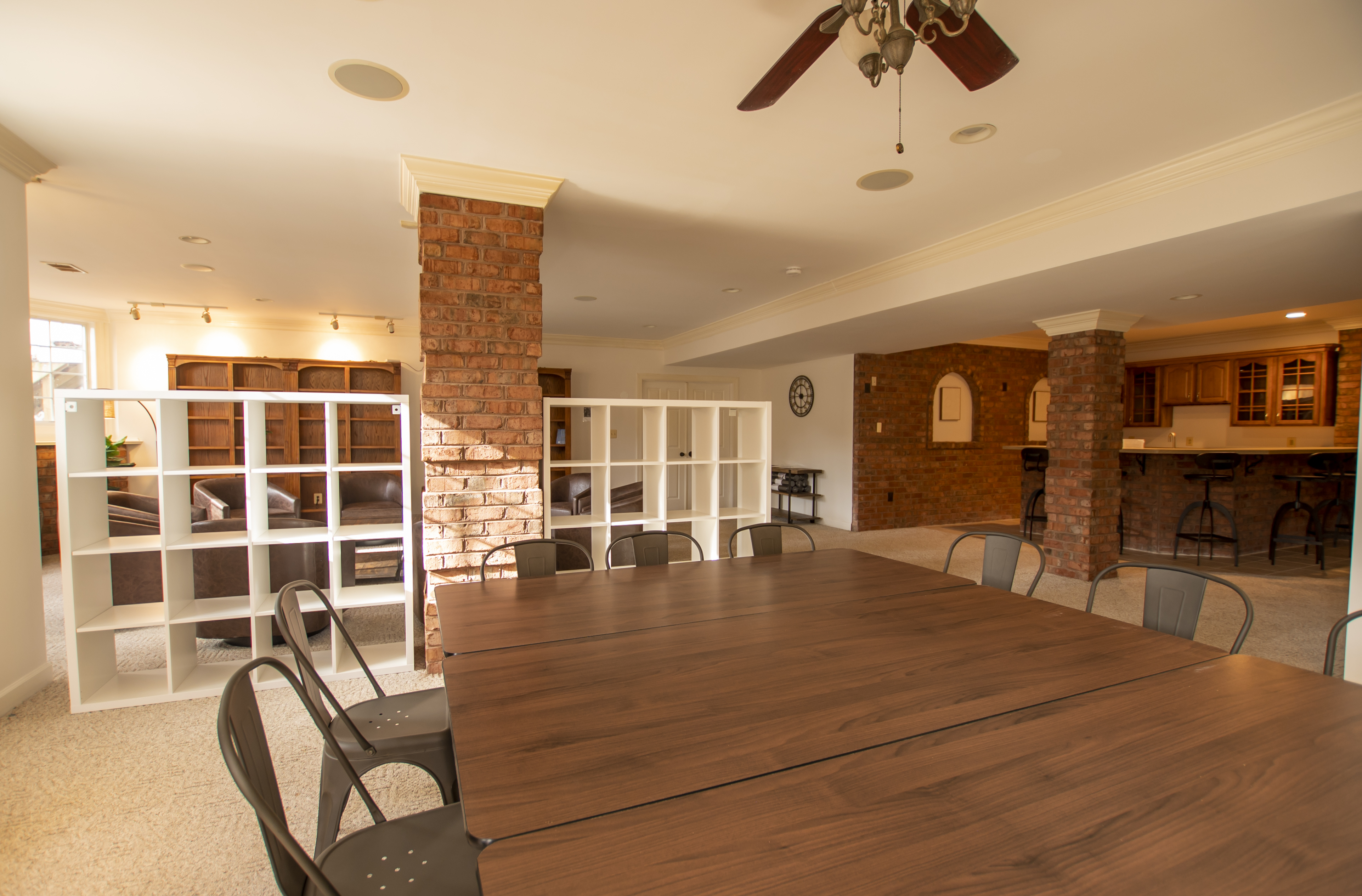 Dining table beside lounge with open layout.