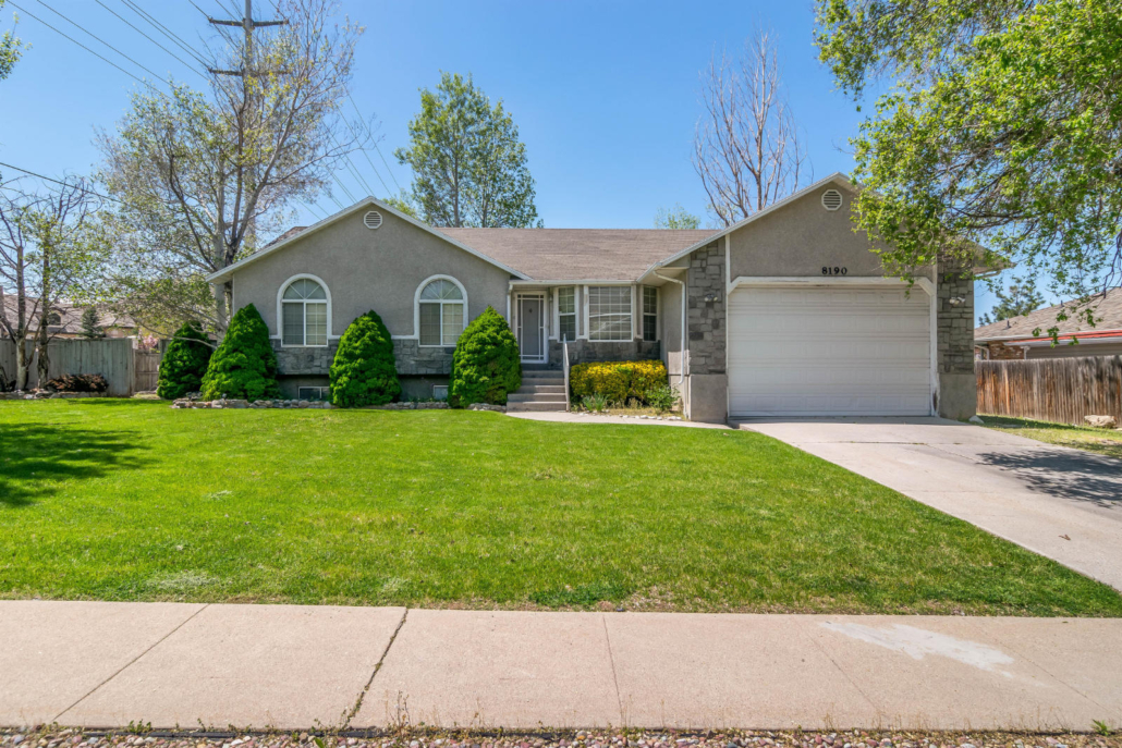 Single-story home with a green front lawn and driveway